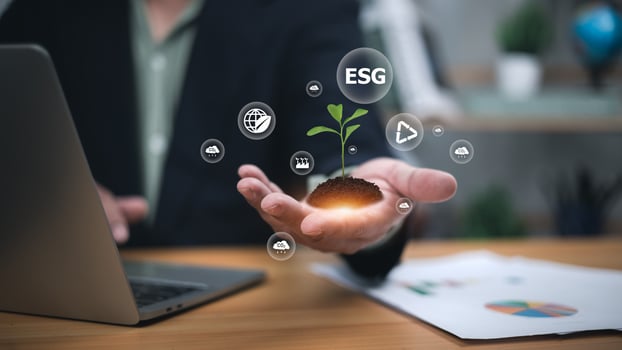 Sustainability, green investment, and responsible business growth. Professional hand holding glowing plant with digital ESG icons like globe, recycling, and carbon emissions. photo