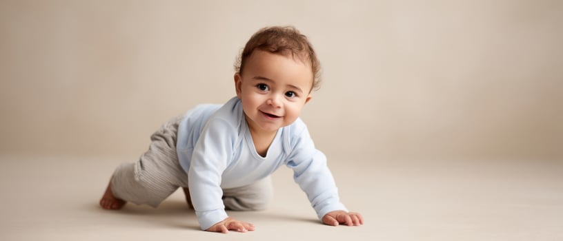 The playful baby crawling and smiling in a warm indoor setting. photo