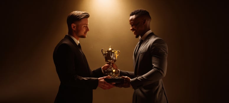 The two men proudly exchanging a prestigious trophy in celebration of success. photo