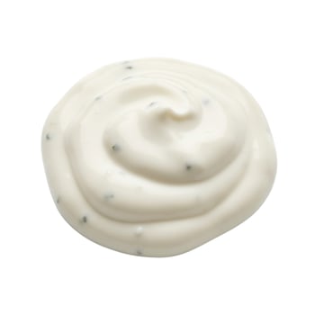 Creamy white sauce or dressing with herbs isolated on white photo