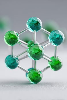 Uranium crystal structure model standing on gray surface photo