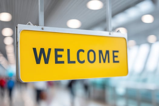 Yellow welcome sign greeting travelers at the airport photo