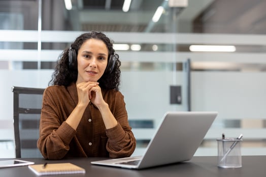 Woman with headphones at laptop photo