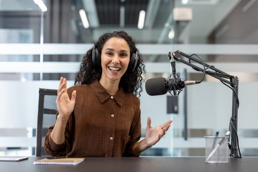 Podcast host speaking into a microphone photo