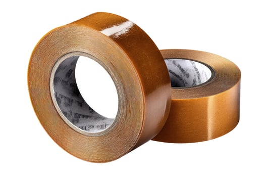 Amber adhesive tape rolls isolated on white background craft supply photo