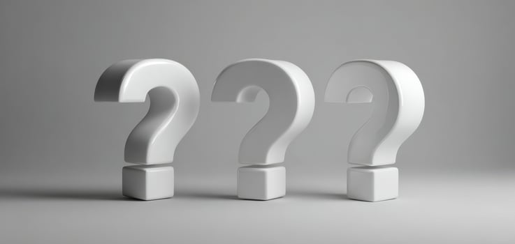 The White Question Marks Standing in a Minimalist Studio Setting photo