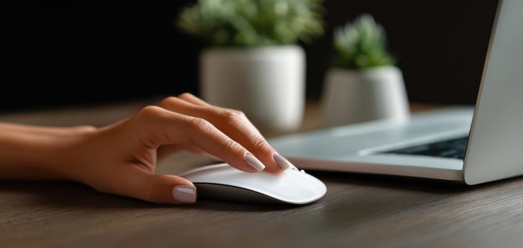 The hand gracefully using a modern computer mouse on a sleek desk. photo