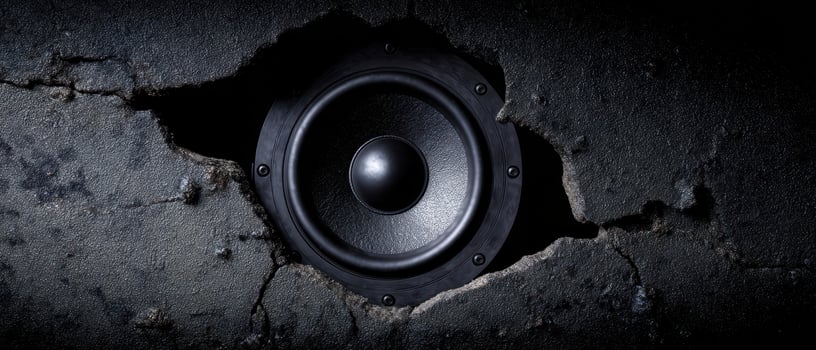 The speaker emerging from a cracked wall in an artistic urban setting. photo