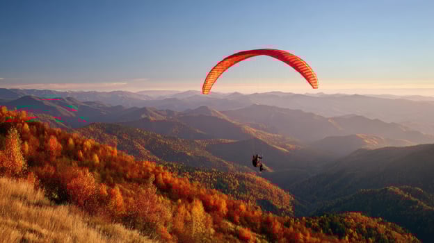 The breathtaking view of a paraglider soaring over colorful autumn mountains photo