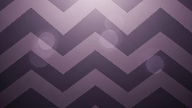 A purple and black chevron wallpaper with a light in the middle photo