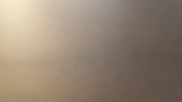 A close up of a leather surface with a light coming from the top photo