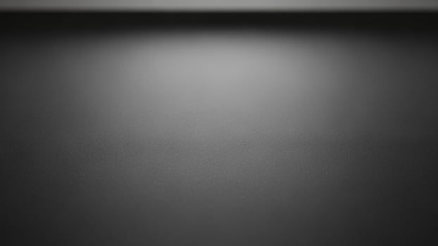sl a ck a nd white photo of a w a ll with a light