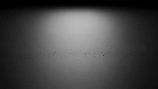 Black and white photo of a dark room with a light shining