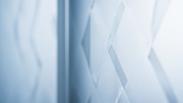 A close up of a white wall with a blue pattern photo