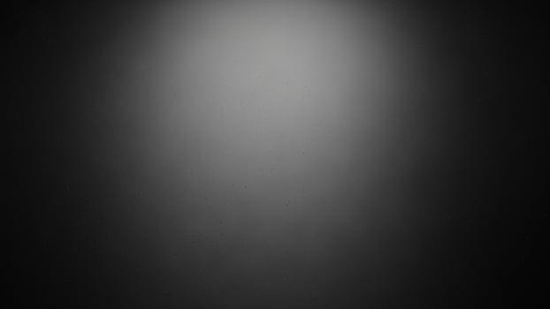 A black and white photo of a light in the dark