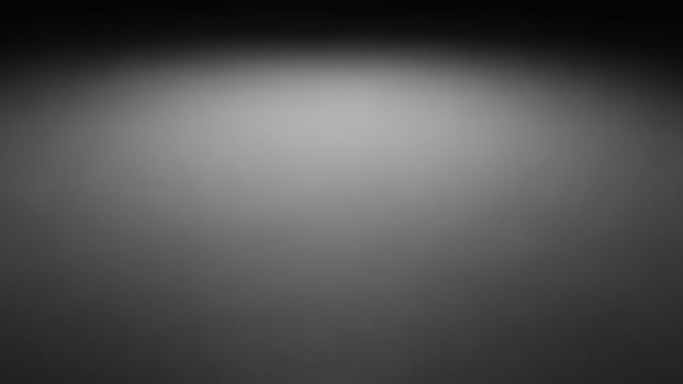 Black and white photo of a spotlight on a wall
