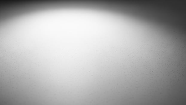 Black and white photo of a light shining on a wall