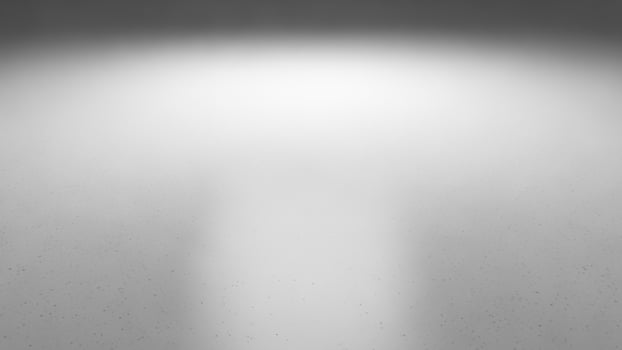A black and white photo of a light shining in the dark