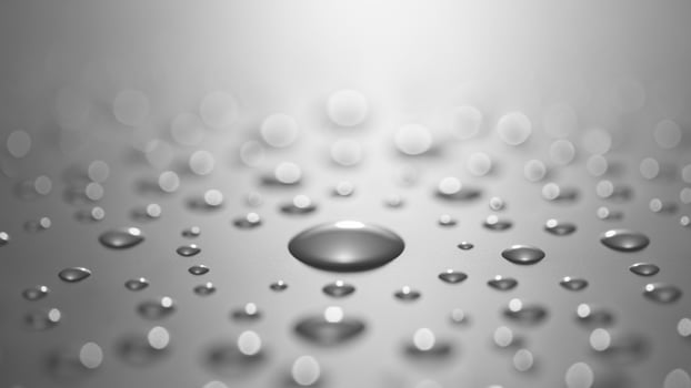 Water drops on a shiny surface with a white background photo