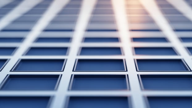 Blue squares on a blue background with a sun shining through photo