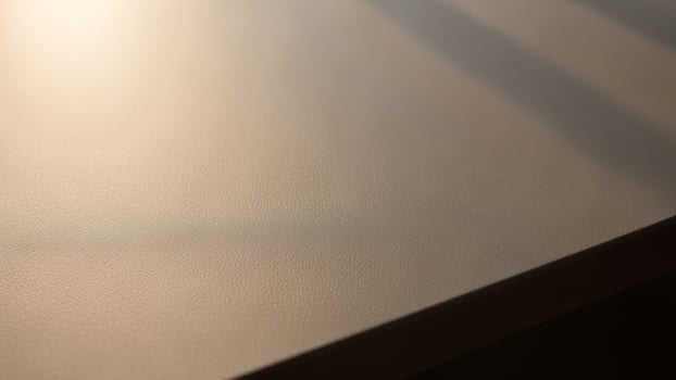 A table with a lamp on it and a light shining on it photo