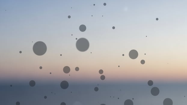 A view of the ocean and some dots on the glass photo