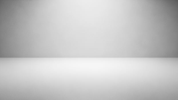 Empty white room with light coming from the ceiling photo