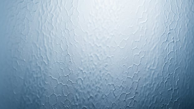 A close up of a blue glass window with water droplets photo