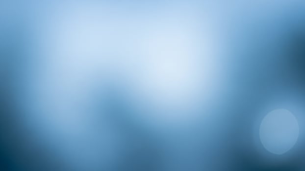A blurry image of a blue sky with a blurry background photo