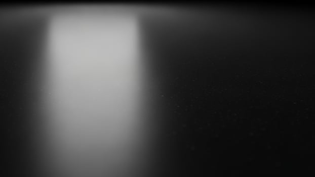 A black and white photo of a light shining through a dark room