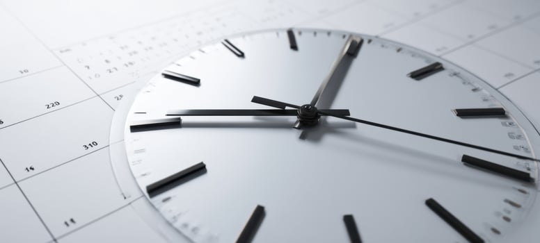 The clock positioned over a calendar illustrating the concept of time management. photo