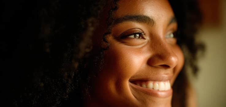 The serene woman with a beautiful smile enjoying natural light and warmth. photo