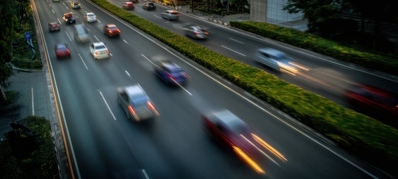 The vibrant motion of cars on a bustling urban highway at night. photo