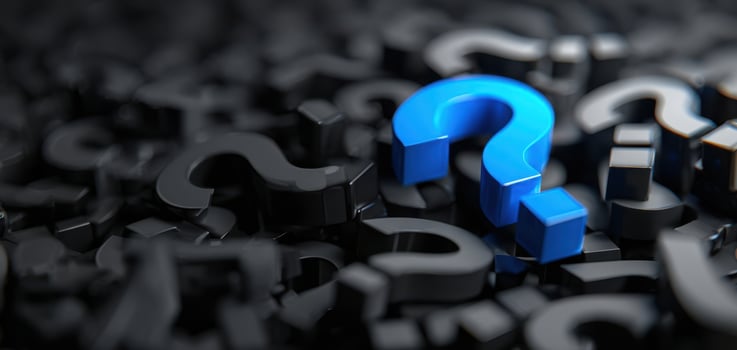 The striking blue question mark standing out against a black background. photo