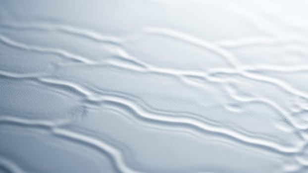 A close up of a white surface with some water photo