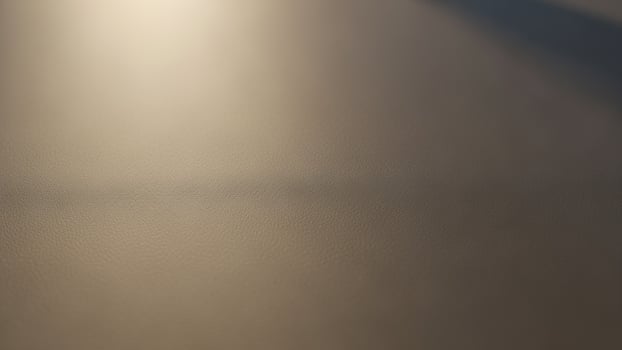 A white light shines on a white surface photo