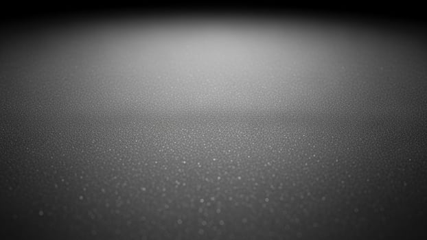 sl a ck a nd white photo of a d a rk surf a ce