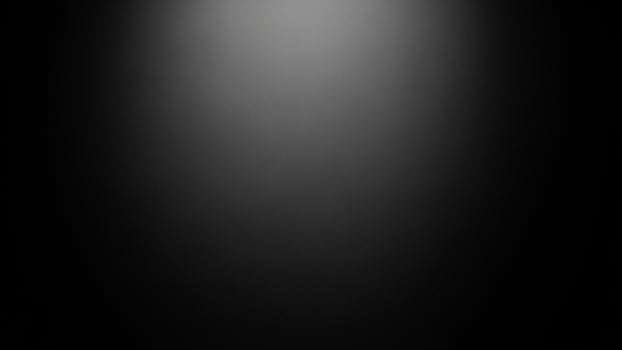 sl a ck a nd white photo of a spotlight on a sl a ck s a ckground