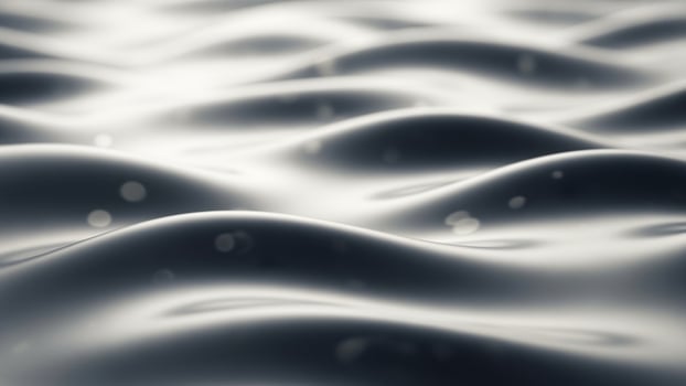 A black and white image of waves on a surface photo