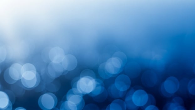 Blue bokeh abstract background with light and dark circles photo