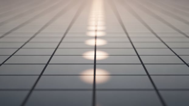 A long line of light shining on a tiled floor photo