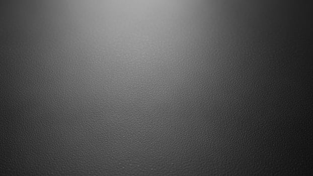 Black leather texture background with light shining through photo