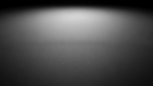 Black and white photo of a dark room with light coming from the ceiling