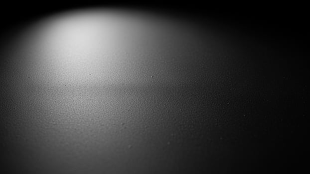 Black and white photo of a light shining on a surface
