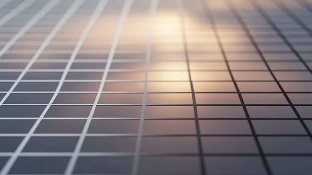 A grid of squares on a surface with a sky in the background photo