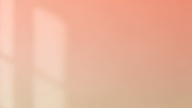 A window with a pink and orange background photo