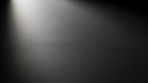 A black and white photo of a spotlight shining on a wall