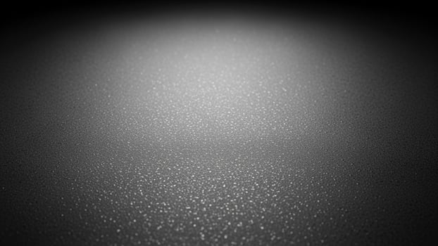Black and white photo of a dark room with a light shining on it