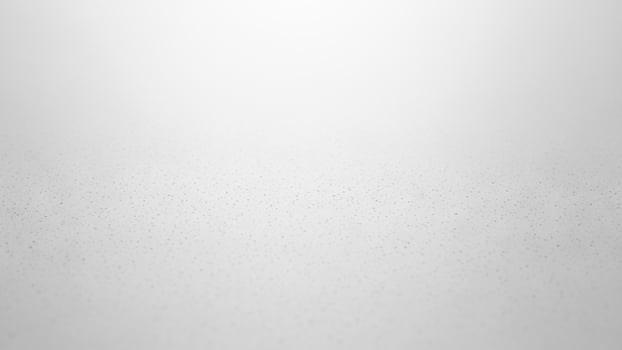 A white and gray background with a light source photo
