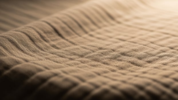 A close up of a blanket with a light shining on it photo